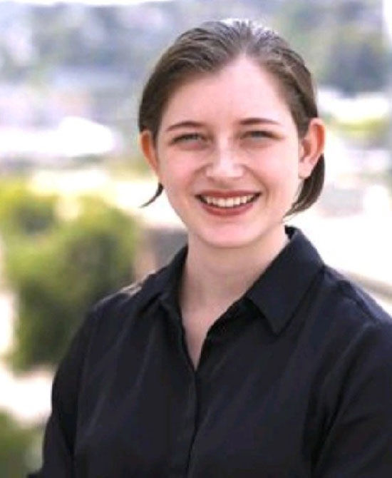 Headshot of Rebecca Bestwick, Senior Digital Marketer at Soothe, smiling outdoors in a black shirt with a blurred city background